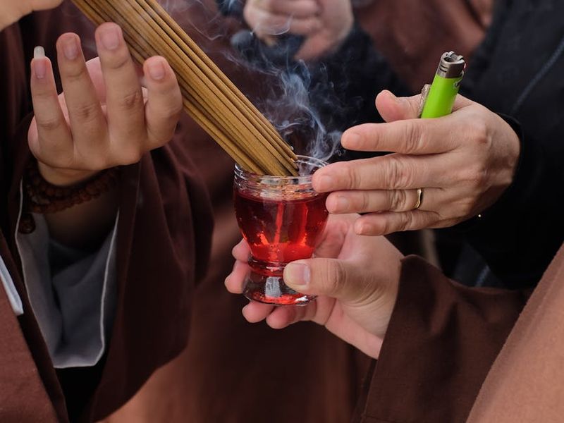 Close up of yoga hands mudra and incense smoke